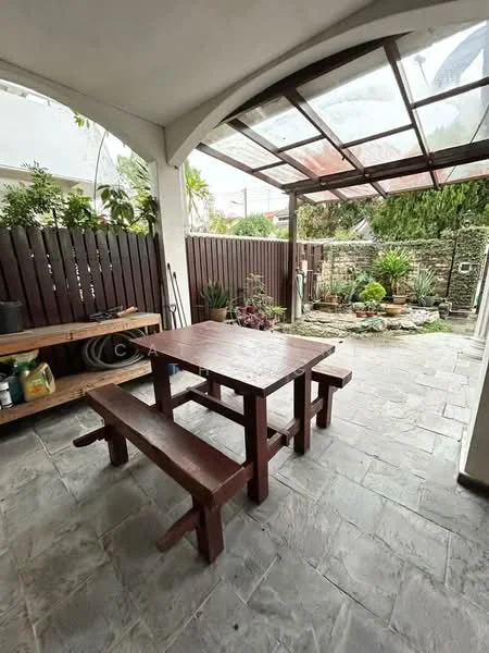 Room features: outdoor dining table with benches, stone flooring, wooden bench, wooden fence, potted plants, landscaped garden area, covered patio, glass roof, decorative stone wall; style: modern; view: garden.