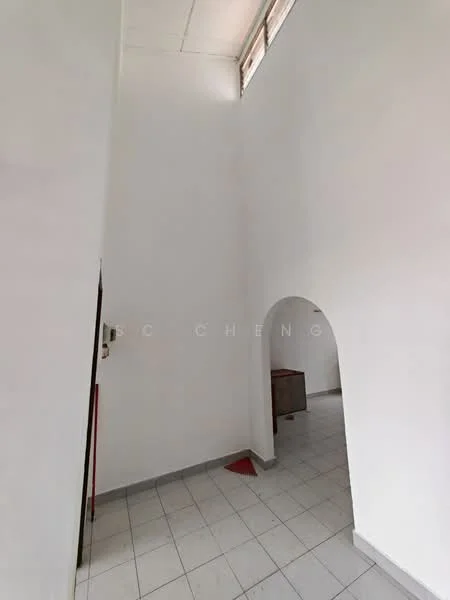 Room features: white painted walls, tile flooring, arched doorway, high ceiling, natural light from windows, corner with furniture.