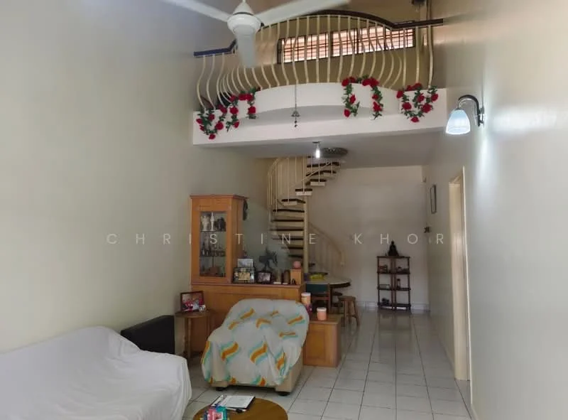 Living features: white painted walls, ceramic tile flooring, 5-blade ceiling fan, sofa covered with white fabric, wooden coffee table, decorative wall shelf, staircase with wooden railing, decorative garland on railing, wall-mounted light fixture, open space with high ceiling; style: modern.