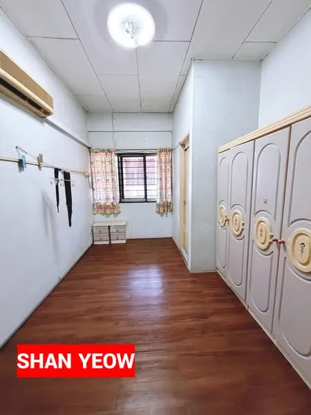 Room features: wooden flooring, white painted walls, ceiling light fixture, window with sheer curtains, built-in wardrobe with decorative doors, air conditioning unit, curtains, two small storage boxes.
