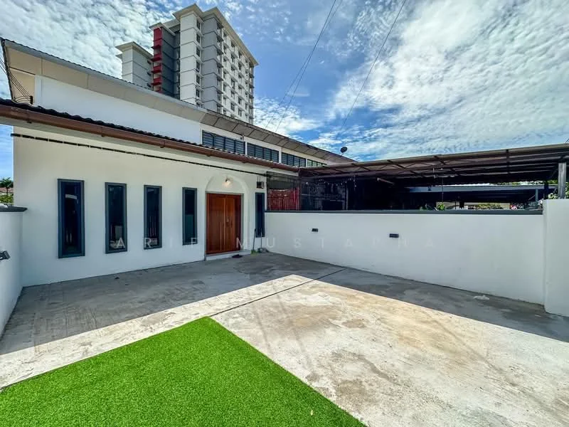Exterior type: detached bungalow; features: white painted facade, flat roof, manicured lawn, paved driveway, car porch with awning, surrounded by greenery, adjacent to multi-storey building, outdoor lighting, single-storey, large windows; style: modern.