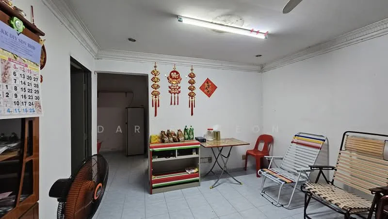 Room features: white painted walls, tile flooring, ceiling fan, recessed lighting, calendar on wall, decorative wall hangings, small table, plastic chairs, wooden shelving unit, bottles on shelf.