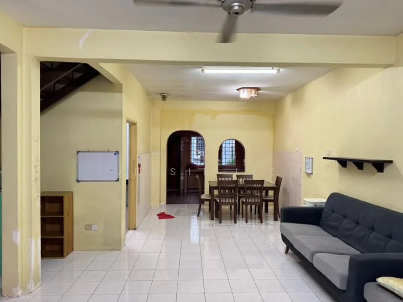 Living features: white painted walls, ceramic tile flooring, 5-blade ceiling fan, sofa in grey fabric, dining table with 6 chairs, wall-mounted shelf, light fixture on ceiling, open layout, staircase visible in background. Room features: white painted walls, ceramic tile flooring.