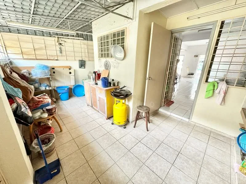 Laundry features: ceramic tile flooring, white painted walls, metal shelving units, blue plastic buckets, wooden stool, yellow gas cylinder, white cabinetry, sink, laundry basket, window with metal grilles, door leading to another room.
