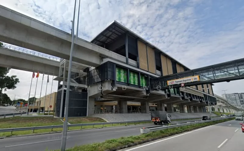 Exterior type: mid-rise condominium; features: glass curtain wall, exposed concrete facade, wooden cladding, recessed balconies, signage visible, pedestrian bridge, multiple levels, surrounded by roadways, landscaped area at base; style: modern.