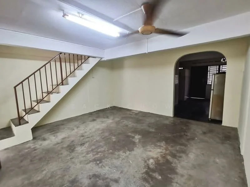 Room features: concrete flooring, white painted walls, ceiling fan, staircase with metal railing, arched doorway, fluorescent ceiling lights, open layout, no visible furniture; style: minimalist.