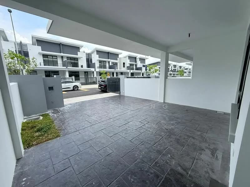 Exterior type: linked terrace house; features: paved driveway, white painted walls, manicured lawn, surrounded by greenery, modern facade, gated entry, visible street view, two-storey houses in background; style: modern.