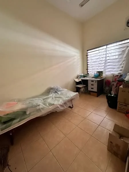 Bedroom features: single bed with protective covering, tile flooring, cream painted walls, window with horizontal slats, study desk, chair, storage boxes, plastic storage containers.