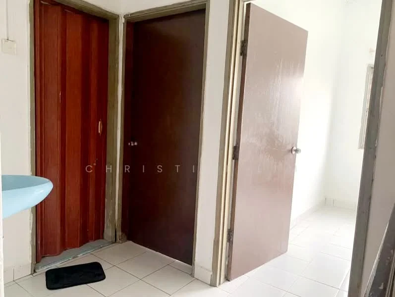 Room features: white painted walls, white tiled flooring, brown wooden doors, blue sink, door with handle, door with knob, mirror on wall, mat at entrance.