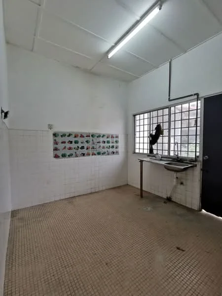 Laundry features: white tiled walls, grey tiled flooring, single-bowl stainless-steel sink, chrome faucet, large window with metal grille, overhead fluorescent lighting, wall-mounted shelving, decorative wall tiles with colorful patterns.