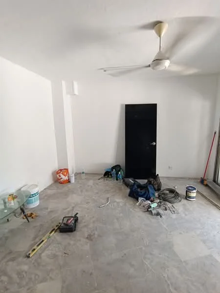 Room features: white painted walls, ceiling fan, stone tile flooring, glass coffee table, various construction materials and tools, empty water bottle, cleaning supplies, dark door, window with no visible treatment.