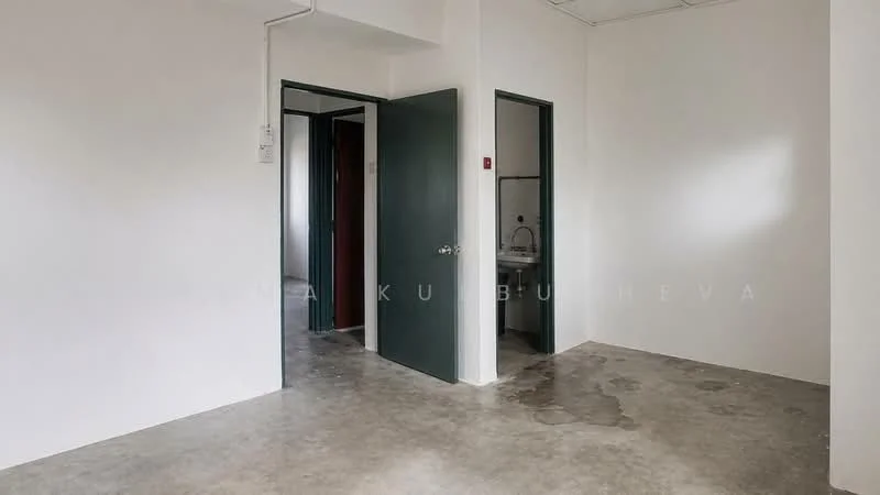 Room features: white painted walls, concrete flooring, two doors, one door with a dark green frame, one door with a light green frame, visible plumbing fixtures, minimal natural light, no visible furniture; style: minimalist.