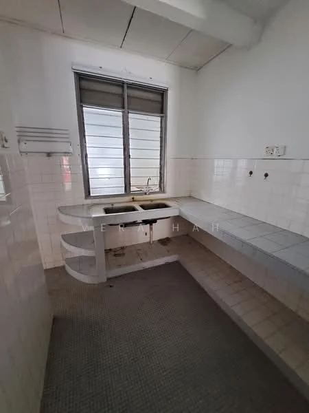 Kitchen features: single-bowl stainless-steel sink, chrome faucet, white tiled walls, grey tiled flooring, built-in countertop, window with horizontal slats, open shelving, no visible appliances.