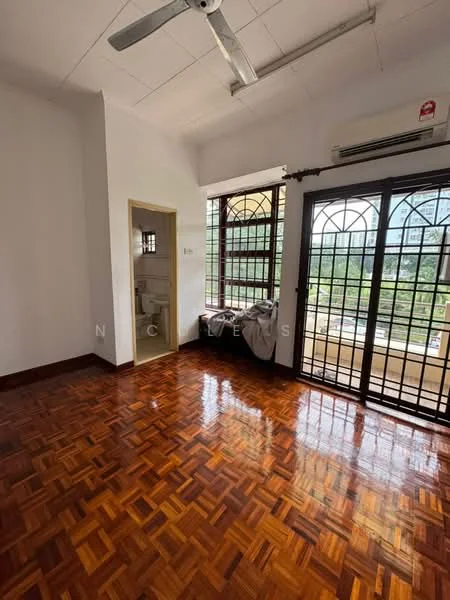 Room features: wooden parquet flooring, white painted walls, ceiling fan, window with metal grille, air conditioning unit, door leading to bathroom, natural light from window, view of greenery outside; view: garden.