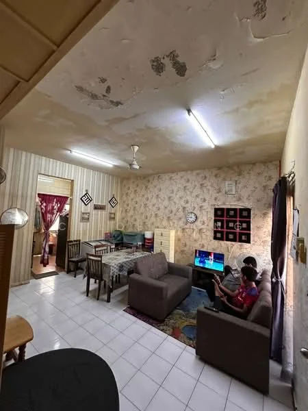 Living features: white tiled flooring, exposed ceiling with visible damage, ceiling fan, sofa in brown fabric, coffee table, wall-mounted TV, decorative wall with floral wallpaper, area rug with geometric pattern, dining table with chairs, open layout to adjacent room; style: traditional. Dining features: dining table with glass top, wooden dining chairs; style: traditional. Room features: doorway leading to another room, curtains in red fabric.