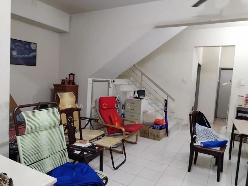 Room features: white painted walls, white tiled flooring, staircase with white railing, ceiling fan, various chairs including folding chairs, wooden cabinet, boxes stacked on the floor, dining table, open layout, doorway leading to another room, window with natural light; style: modern.