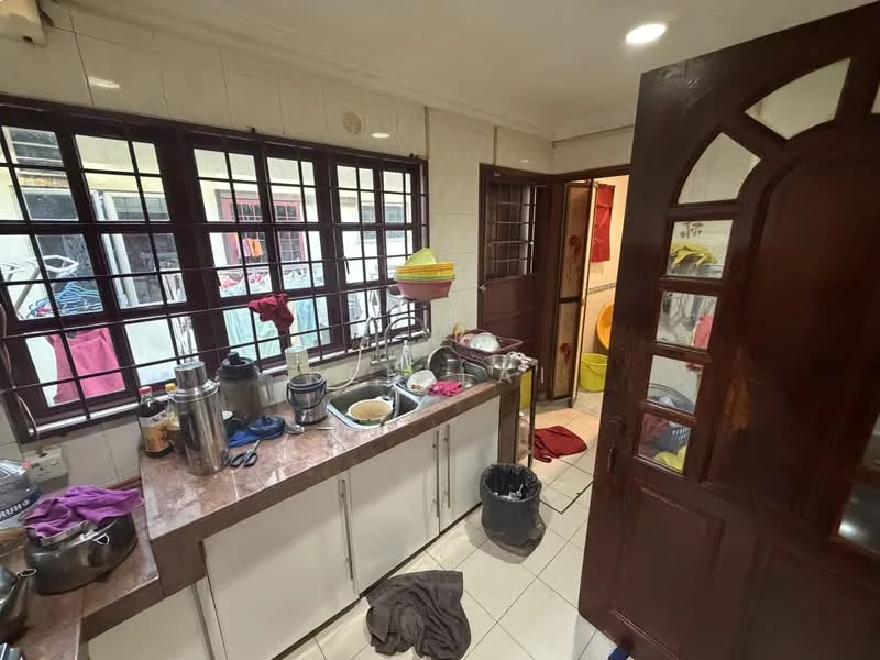 Kitchen features: brown granite countertop, white cabinetry, stainless-steel sink, chrome faucet, tile backsplash, ceramic tile flooring, multiple cooking utensils, kitchen towels, garbage bin, window with metal grilles, natural light from window, open shelving, floor-mounted cabinets.