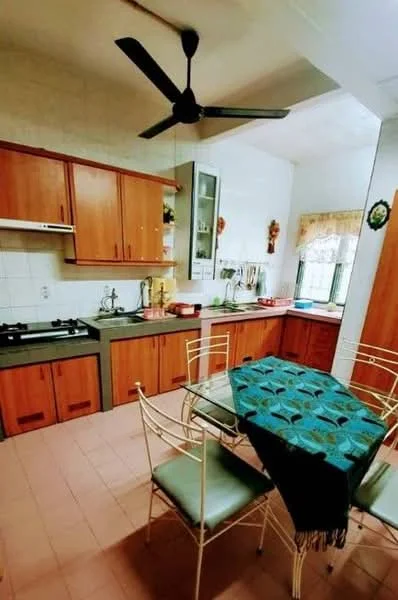 Kitchen features: wood cabinetry in brown, grey countertop, stainless-steel sink, chrome pull-down faucet, 4-burner gas hob, built-in oven, refrigerator, ceiling fan, window with curtain, tile backsplash, pink tile flooring, dining table with metal chairs, decorative wall art; style: traditional.