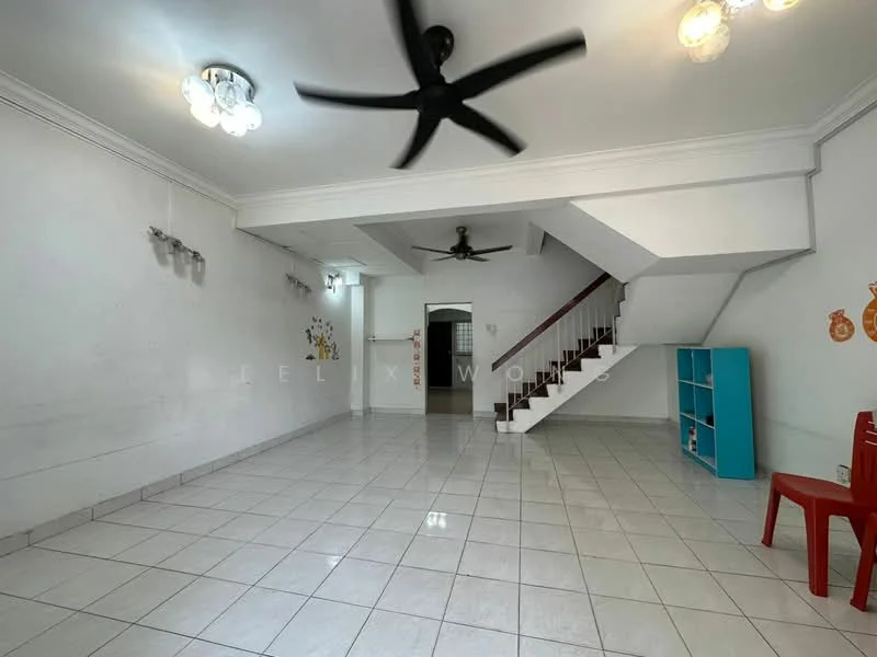 Living features: white painted walls, glossy white tile flooring, 5-blade ceiling fan, 2 ceiling light fixtures, staircase with wooden railing, open layout, blue bookshelf, red plastic chair.
