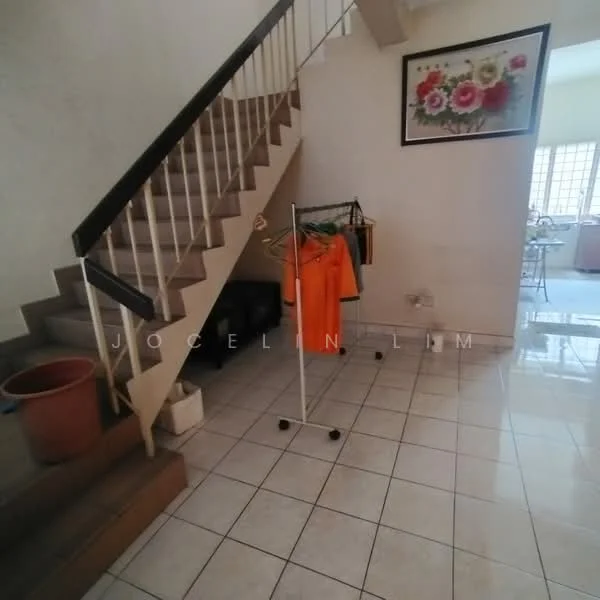Room features: staircase with wooden steps, white painted walls, ceramic tile flooring, hanging clothes rack, potted plant, framed artwork with floral design, natural light from window, open space layout.