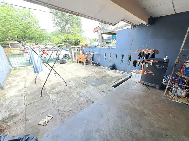 Exterior features: concrete flooring, clothes drying rack, washing machine, fenced area, outdoor space, garden view, gravel pathway, exposed brick wall, utility area.