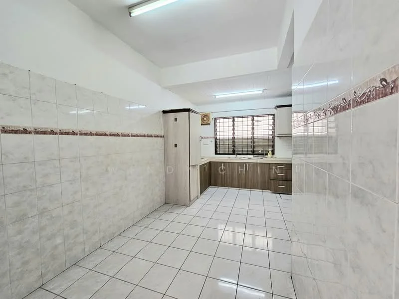 Kitchen features: white tiled walls, cream tiled backsplash with decorative border, light brown cabinetry, white countertop, stainless-steel fridge, ceramic tile flooring, window with metal grille, overhead fluorescent lighting.