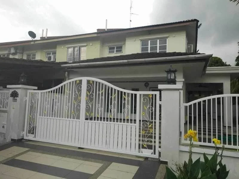 Exterior type: semi-detached house; features: white painted facade, flat roof, double-storey, manicured lawn, paved driveway, decorative gate, outdoor lighting fixtures, surrounded by greenery; style: modern.
