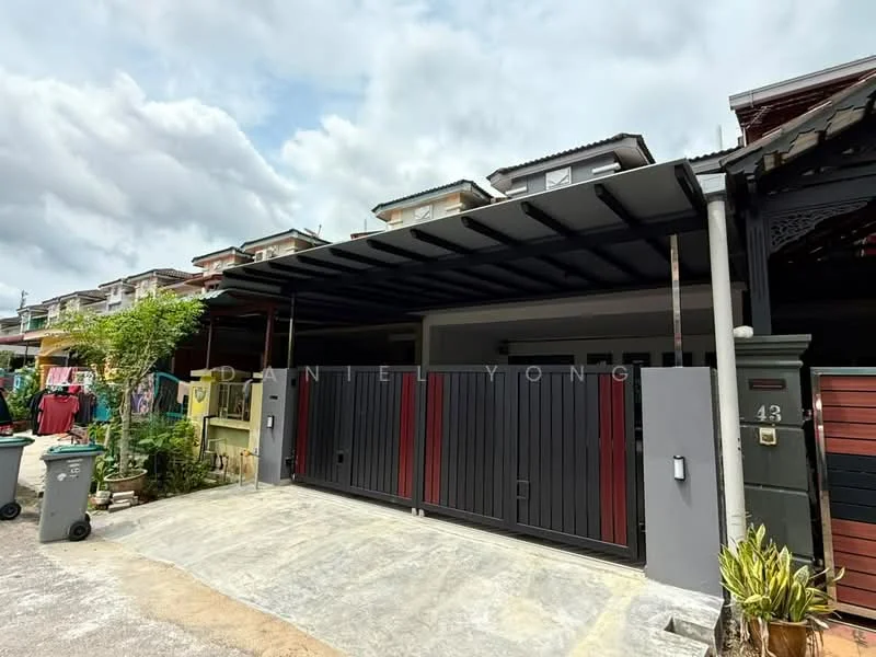 Exterior type: linked terrace house; features: grey painted facade, red accent gates, covered car porch, concrete driveway, manicured garden, visible neighboring houses, outdoor lighting, paved walkway; style: modern.