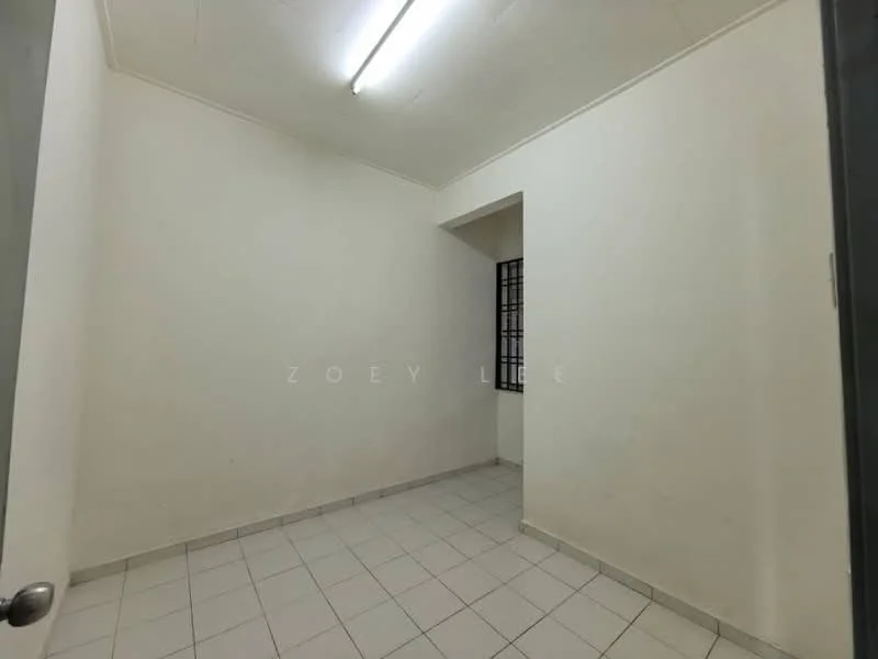 Room features: white painted walls, tile flooring, single window with metal grille, fluorescent ceiling lights.