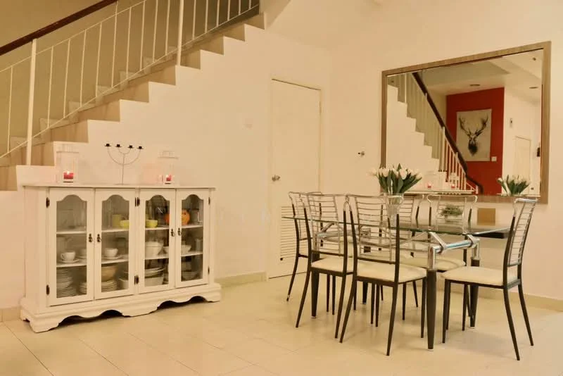 Dining features: glass dining table, 6 upholstered dining chairs, white sideboard with glass doors, decorative vase with flowers, white tiled flooring, mirror on wall, staircase in background, red accent wall; style: modern.