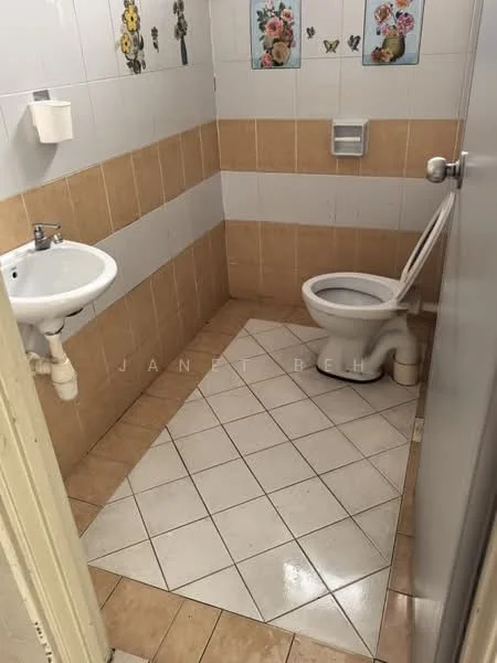 Bathroom features: white ceramic sink, chrome faucet, white toilet, tile flooring, beige wall tiles, white wall tiles, decorative wall art with flowers and butterflies, toilet paper holder, wall-mounted soap dish.
