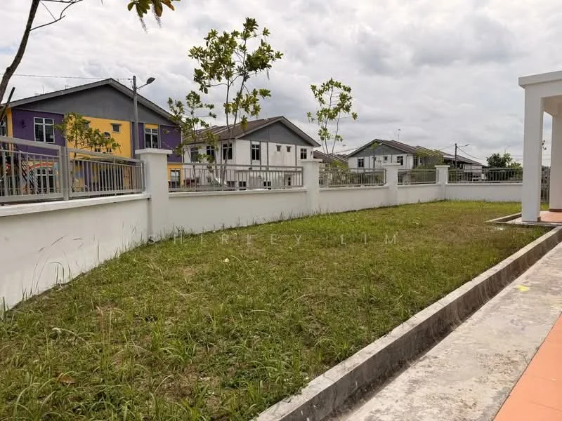 Exterior features: manicured lawn, fenced perimeter, paved walkway, surrounding residential houses, landscaped area with small trees, grey concrete wall, open space, cloudy sky; style: modern.