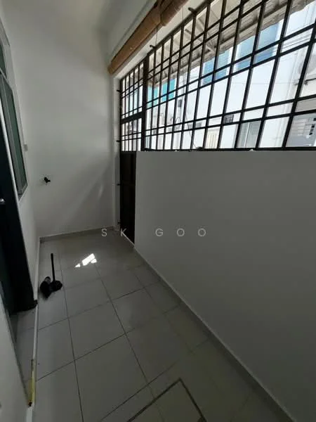 Room features: white painted walls, grey tiled flooring, large windows with metal grilles, door leading outside, natural light from windows.