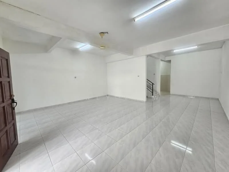 Room features: white painted walls, polished ceramic tile flooring, exposed ceiling with fluorescent lighting, ceiling fan, staircase visible in background, large open space, no visible furniture or decor; style: minimalist.