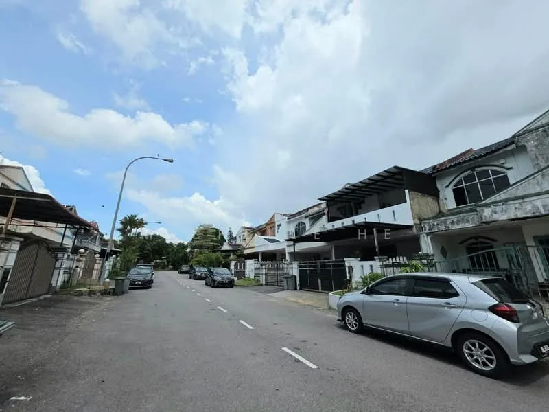 Exterior type: linked terrace house; features: two-storey linked terrace houses, white painted facade, balconies on upper floors, driveways for parking, manicured front lawns, street view with parked cars, surrounded by greenery, cloudy sky; style: modern.