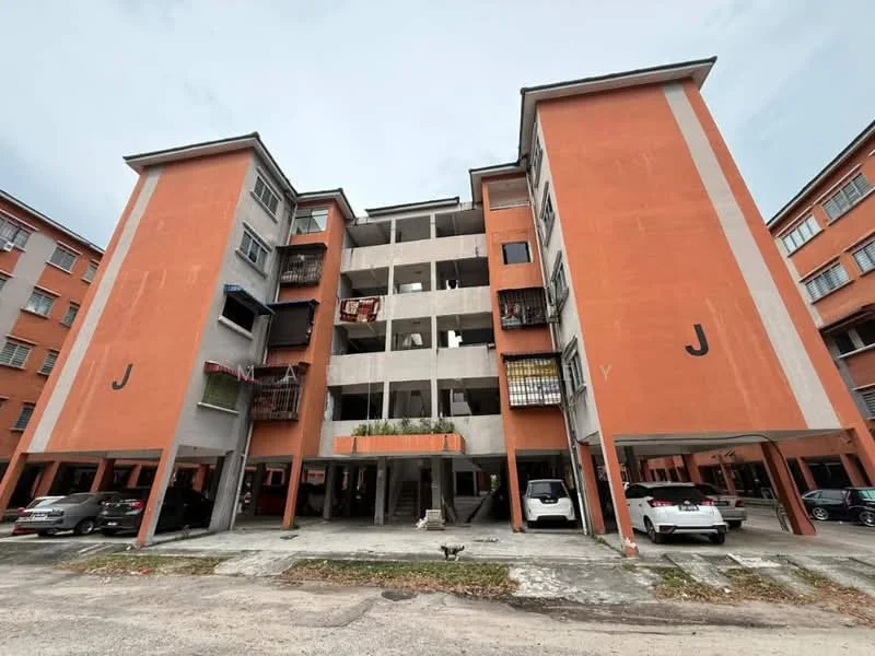 Exterior type: low-rise apartment block; features: orange painted facade, concrete structure, balconies with railings, ground-level parking, multiple storeys, visible parking spaces, exposed concrete elements, symmetrical design; style: modern.