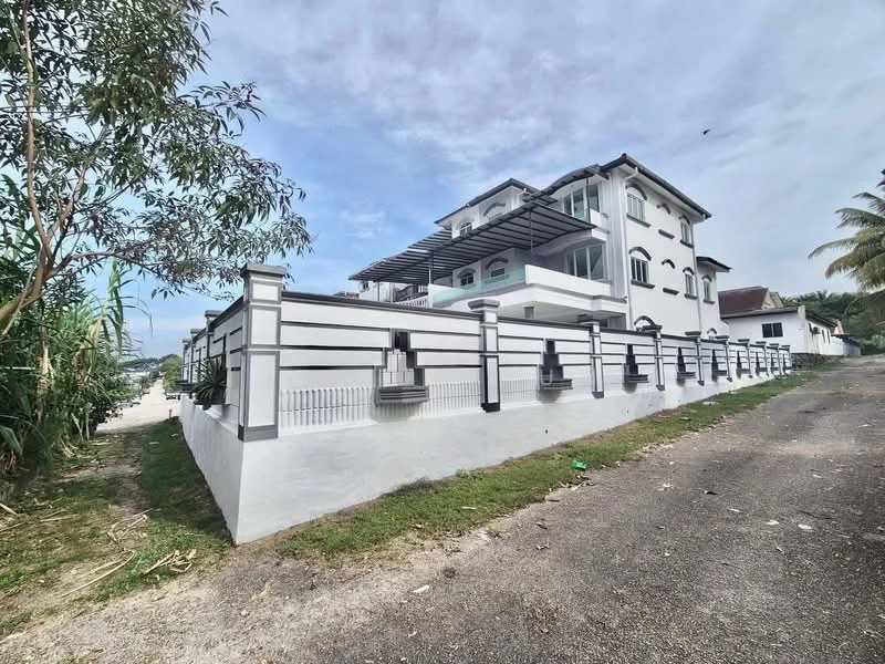 Exterior type: detached bungalow; features: white painted facade, flat roof, two-storey building, recessed balconies, metal railing, manicured lawn, paved driveway, surrounded by greenery, large windows, covered porch, perimeter fence; style: modern.
