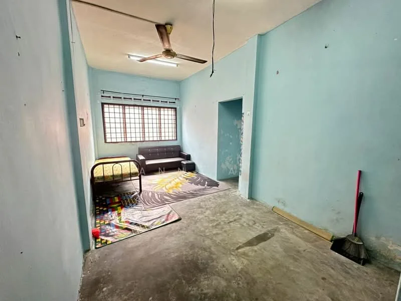 Room features: light blue painted walls, concrete flooring, ceiling fan, window with grid pattern, black sofa, single bed with metal frame, colorful area rug, broom, dustpan; style: minimalist.