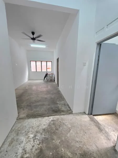 Room features: white painted walls, concrete flooring, ceiling fan, window with horizontal slats, doorway leading to another room, doorway leading outside, natural light from window; style: minimalist.