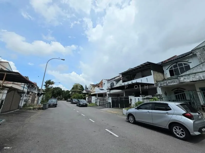 Exterior type: linked terrace house; features: two-storey linked terrace houses, white painted facade, balconies on upper floors, driveway with interlocking pavers, manicured lawns, street view with parked cars, surrounded by greenery, cloudy sky; style: modern.
