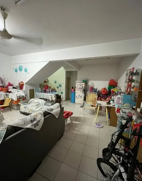 Living features: white painted walls, tile flooring, 5-blade ceiling fan, sofa in dark color, coffee table, dining table with chairs, refrigerator, decorative items on shelves, houseplants in pots, stroller, various items on surfaces.