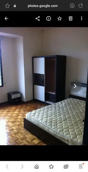 Bedroom features: wooden flooring, white painted walls, single bed with mattress, built-in wardrobe with sliding doors, nightstand, window with grid pattern, natural light, decorative wall.