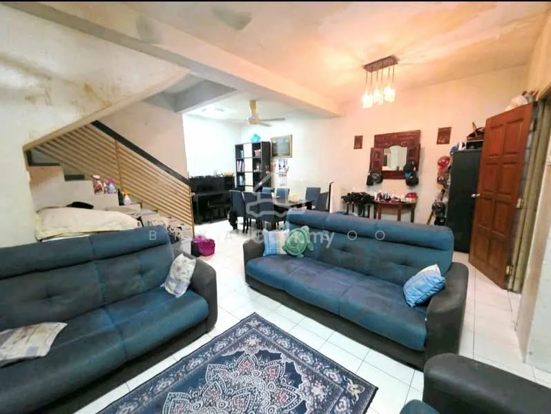 Living features: 2 grey fabric sofas, area rug with intricate pattern, white tiled flooring, ceiling fan, wall-mounted mirror, wooden staircase, decorative wall with framed artwork, dining table visible in background, dark wood cabinet in background.