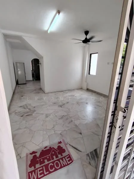 Living features: marble flooring, white painted walls, ceiling fan, window with natural light, doorway leading to kitchen, welcome mat at entrance. Kitchen features: stainless-steel fridge, open layout to living area.