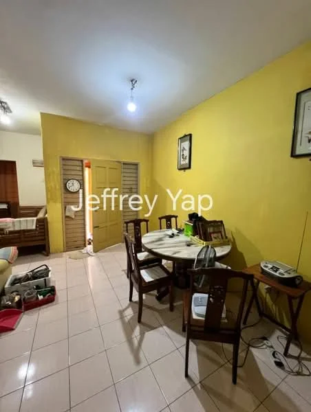 Dining features: yellow painted walls, white tiled flooring, round dining table, wooden dining chairs, wall clock, framed artwork, door with louvered panels, light fixture on ceiling. Room features: sofa, bed with bedding visible, side table, electrical appliances on table.