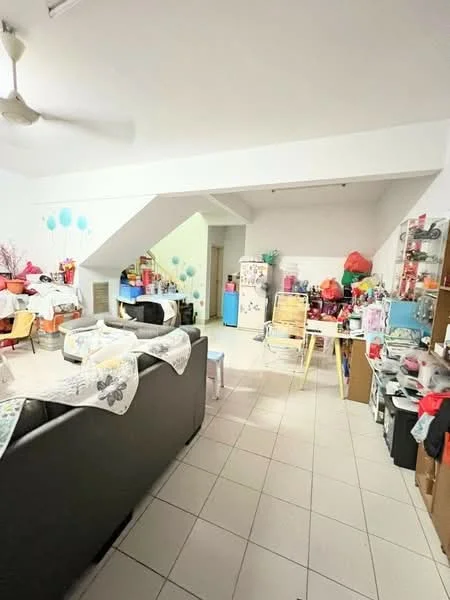 Living features: white painted walls, tiled flooring, 5-blade ceiling fan, sofa in black fabric, coffee table, dining table with chairs, refrigerator in white, kitchenette area with cabinets, decorative items on shelves, colorful balloons on walls, open layout, staircase in background.