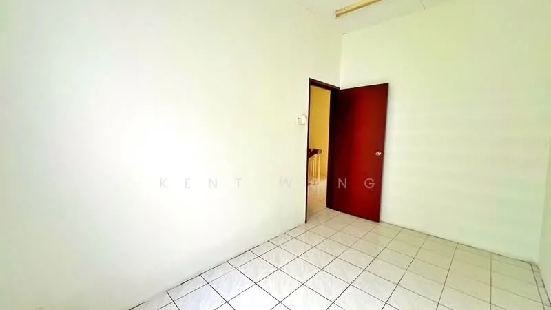 Room features: white painted walls, tile flooring, single wooden door, no visible windows, empty space.