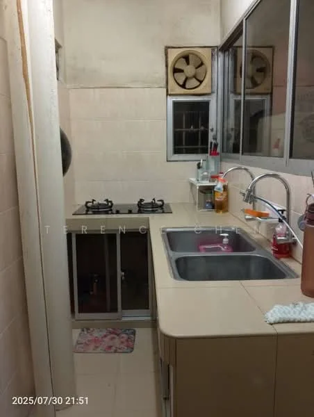 Kitchen features: double-bowl stainless-steel sink, chrome pull-down faucet, laminate countertop, wall-mounted gas hob with 2 burners, glass window with metal grille, cream tiled walls, light-colored floor tiles, wall-mounted exhaust fan, open shelving, kitchen towel hanging, dish soap dispenser, kitchen sponge holder.