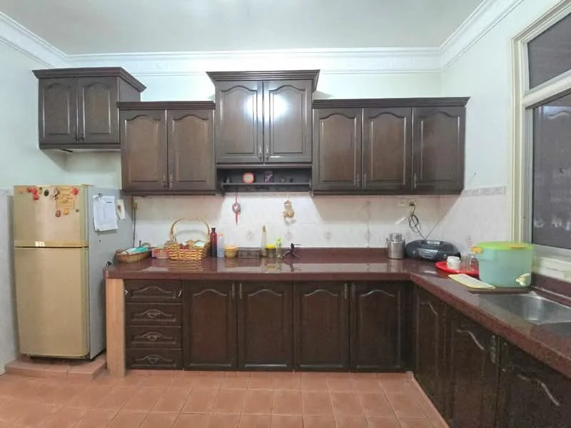Kitchen features: dark wood cabinetry, granite countertop, stainless-steel sink, chrome faucet, built-in oven, freestanding fridge in beige, tile backsplash, wall-mounted shelves, ceramic tile flooring, window with natural light, basket for storage, kitchen utensils on countertop; style: traditional.