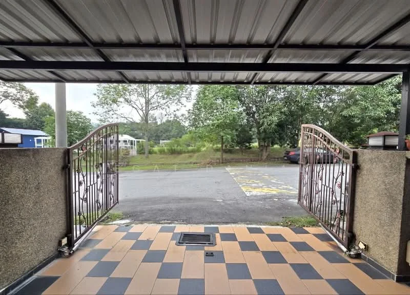Exterior type: linked terrace house; features: metal gate, paved driveway with alternating black and beige tiles, covered car porch, landscaped greenery in view, concrete wall, roof with metal sheeting, parking area visible, surrounding trees; style: modern.